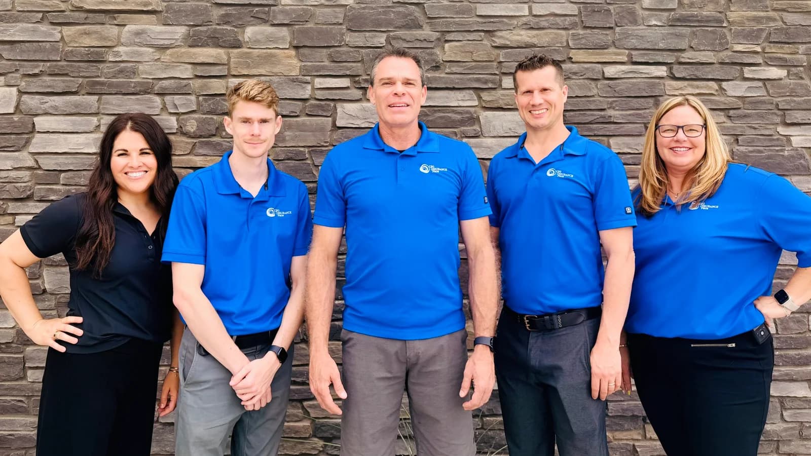 The five-person CSG Insurance Pros team in branded blue polo shirts